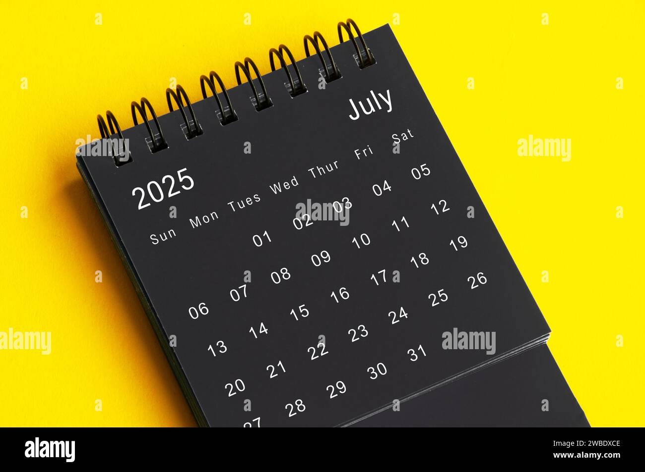July 2025 Black And White Desk Calendar On Yellow Cover Background 